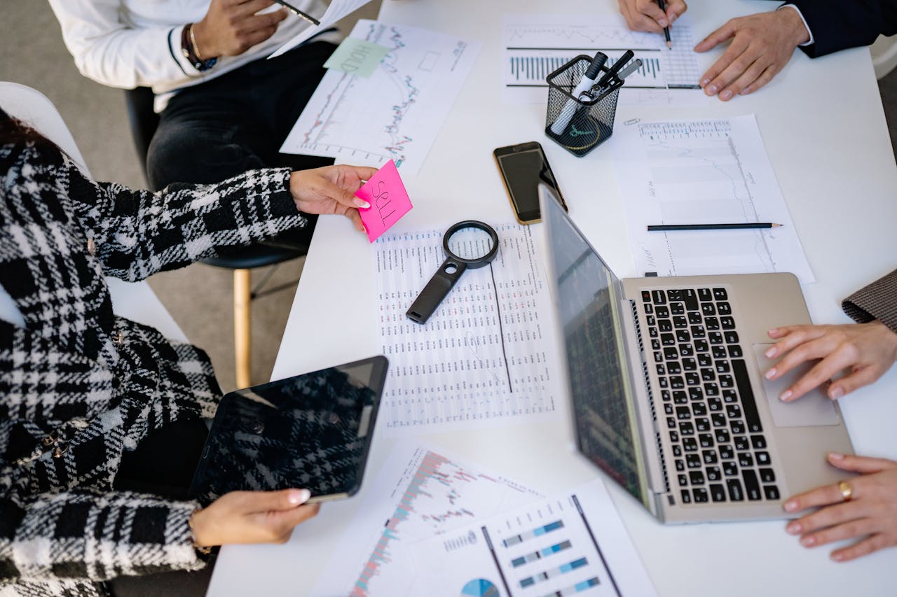 why-choose-us Business professionals collaborating on financial data analysis in a modern office setting.